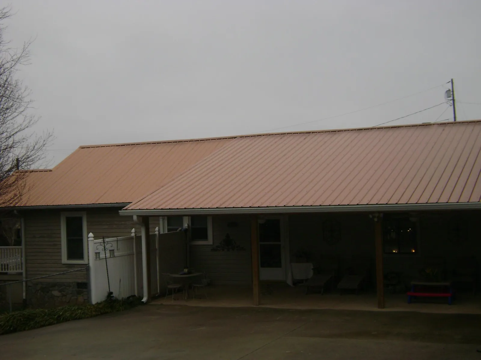 Copper toned metal roof over a wide covered patio in Oxford